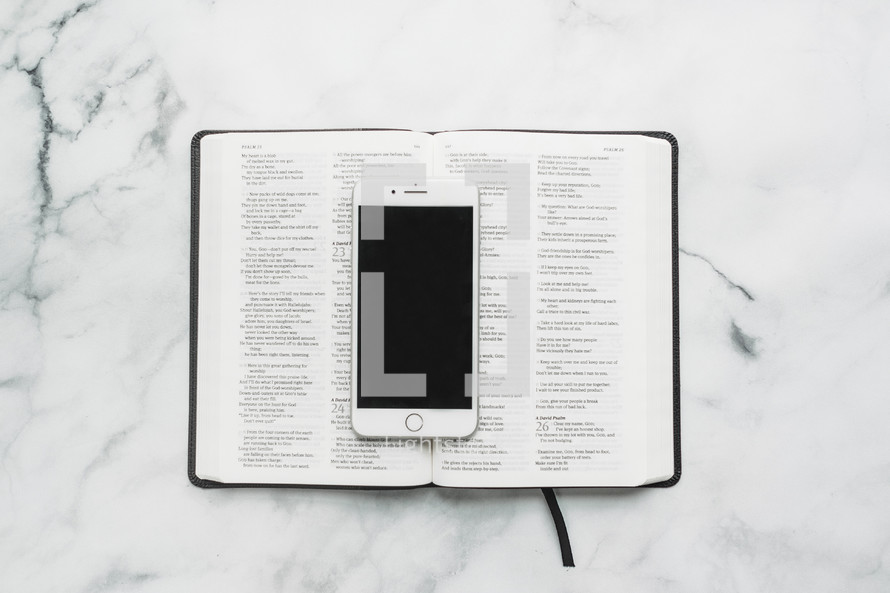 smartphone resting on the pages of a Bible 