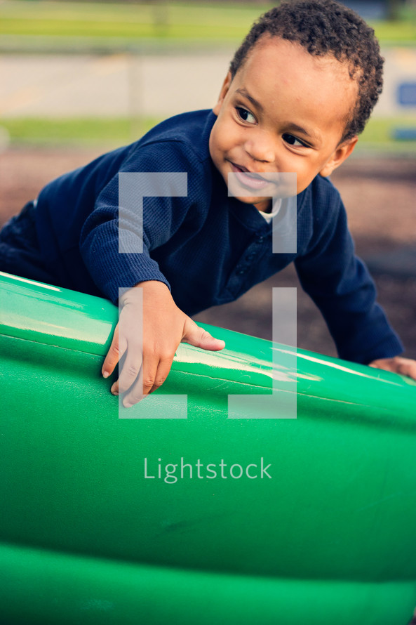 Boy on a playground slide.
