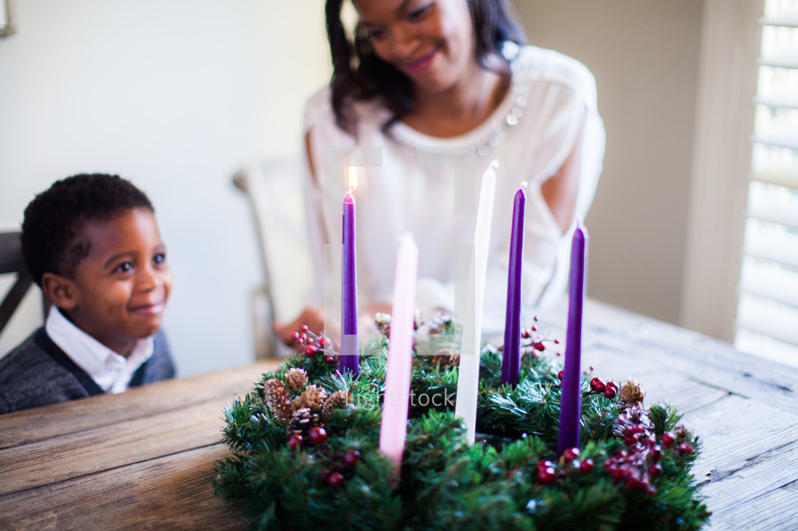 mother and son lighting an Advent wreath 