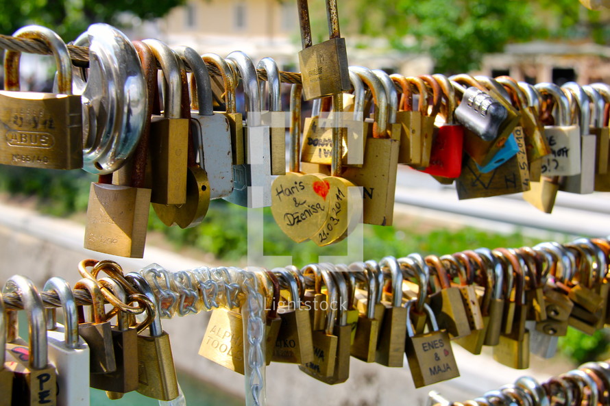 Love locks on a bridge railing.
