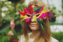 a woman wearing a masquerade mask
