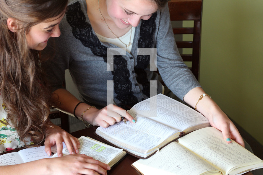 Two females studying the Bible together.