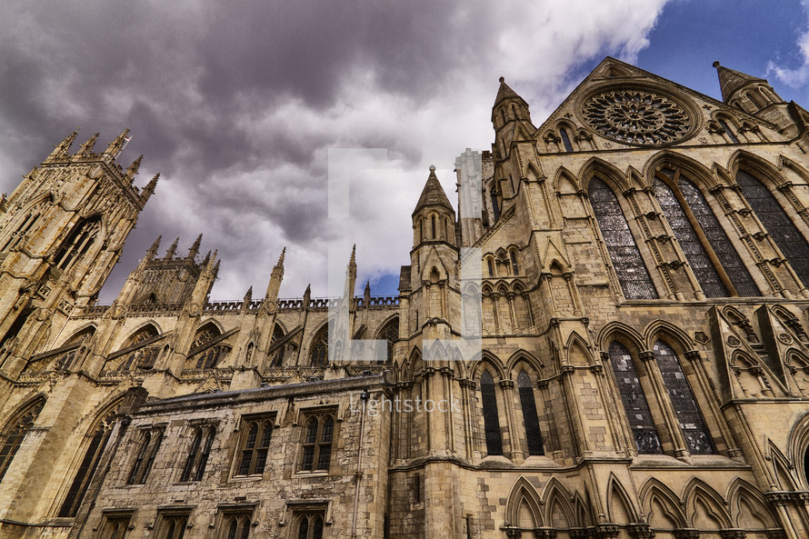 Ancient cathedral under stormy clouds.
