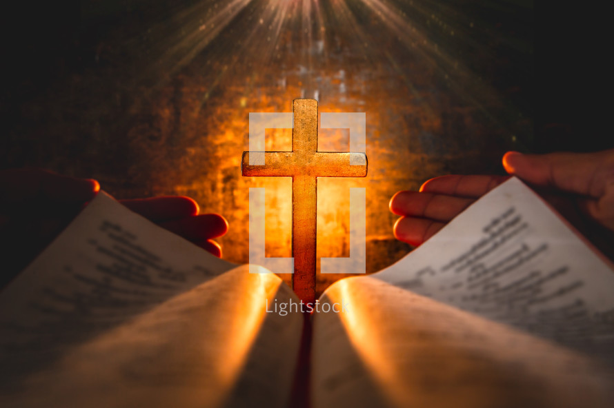 glowing cross in front of an open Bible 