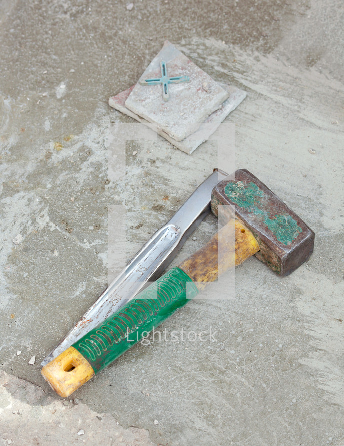 Awl and big hammer on concrete flooring