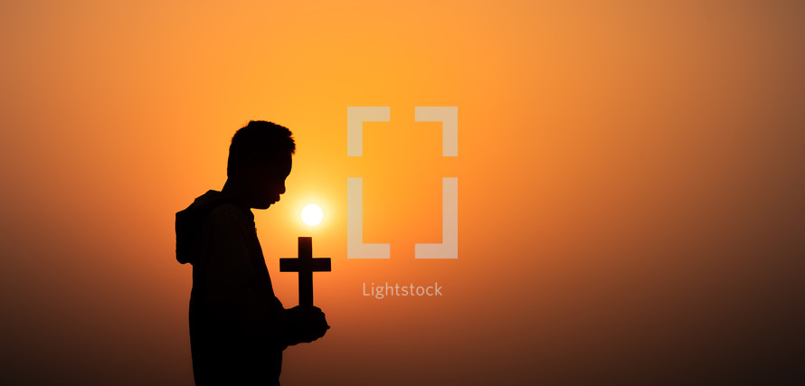 Christian holding the Cross with light sunset background, Christians should worship and thank God, Christian silhouette