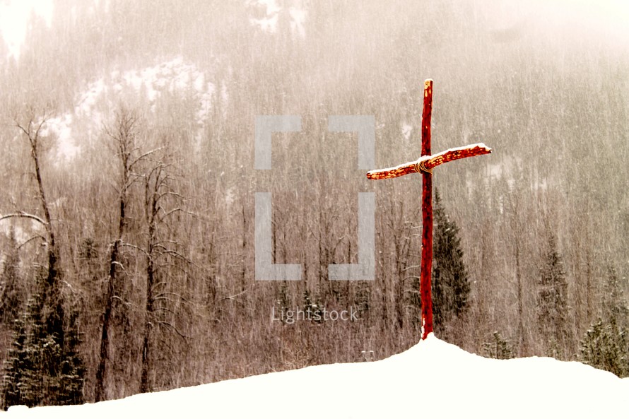 wood cross in the snow 