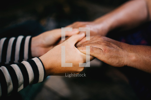 Couple holding hands in prayer — Photo — Lightstock