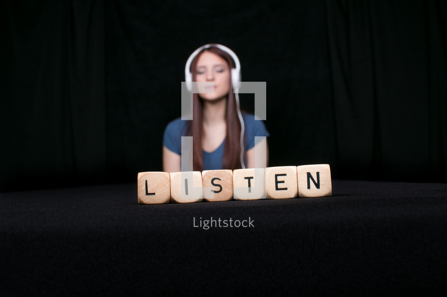girl with headphones and the word listen