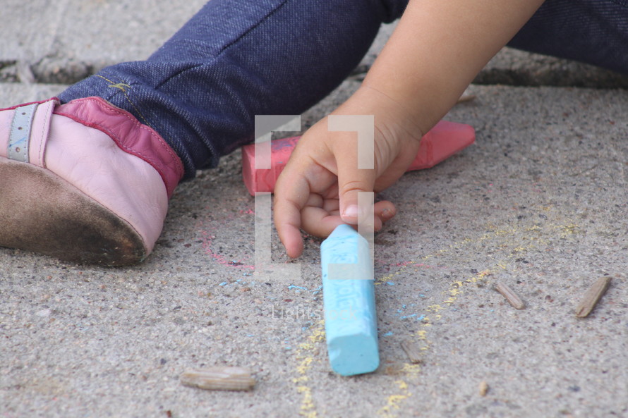 Child's hands with sidewall chalk,