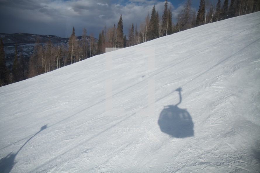 ski lift shadows in the snow