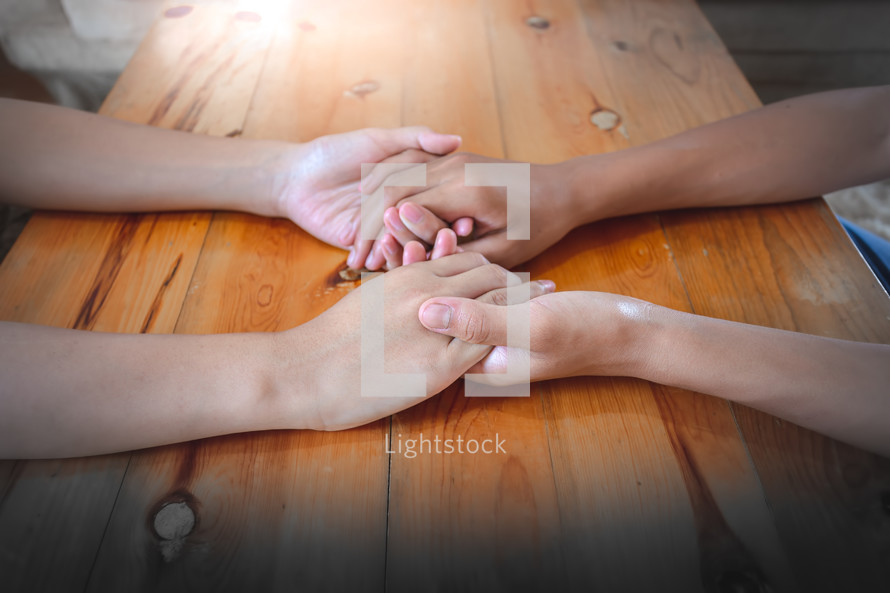 holding hands in prayer 