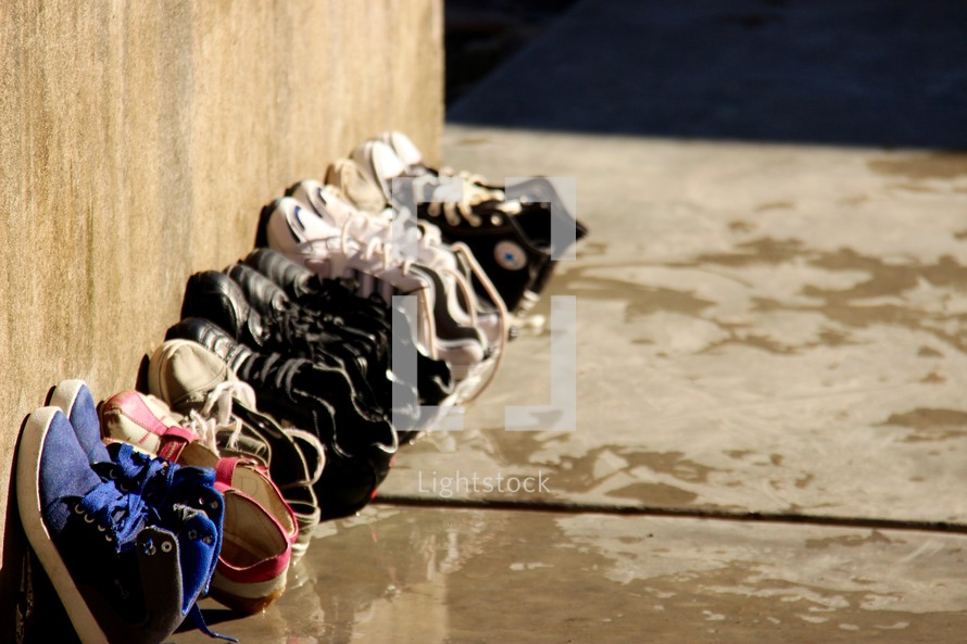 a row of sneakers against a wall 