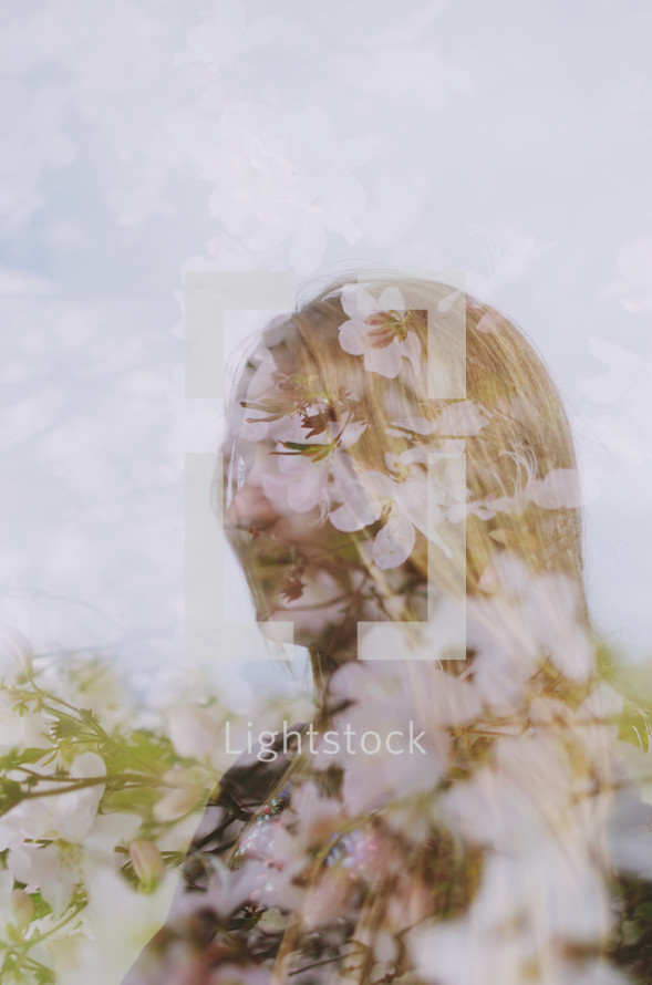reflection of a woman in glass and spring flowers 