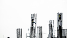men climbing scaffolding 