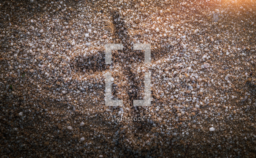 cross imprint in gravel 