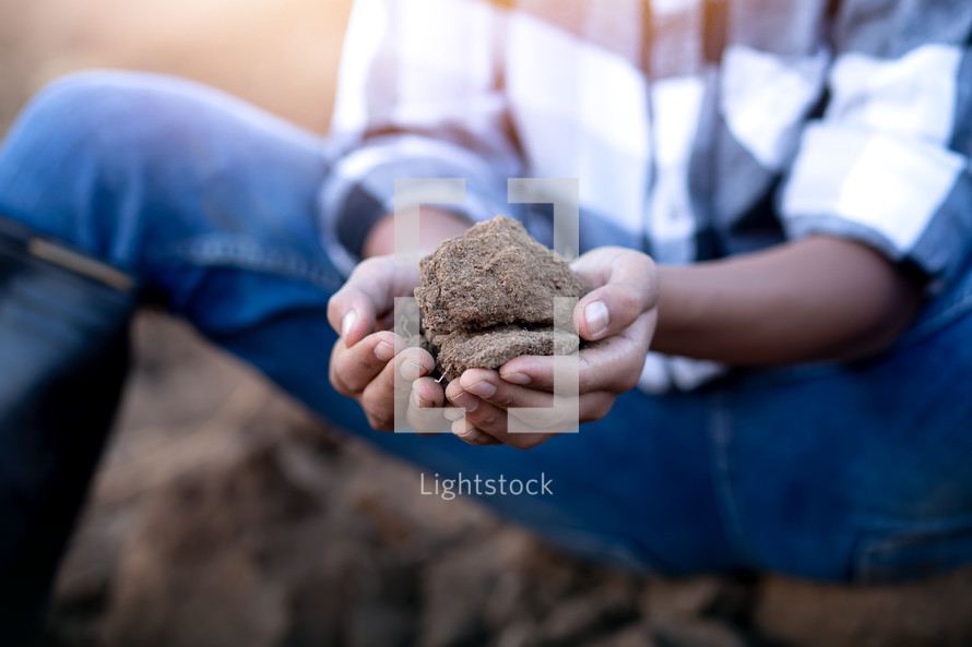 cupped hands with soil 