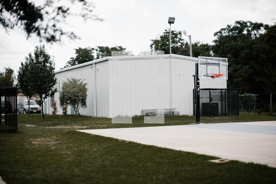 a basketball court in a city park 