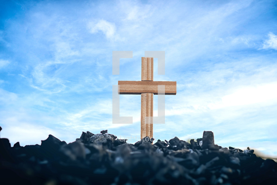 cross in ashes and blue sky 