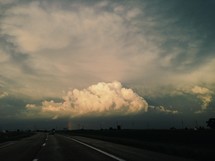 distant rainbow and storm clouds 