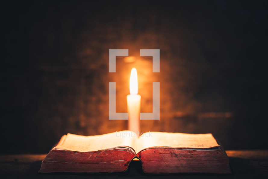 open Bible and candlelight 