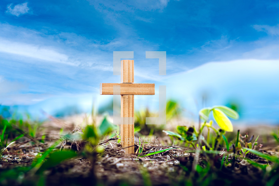 cross in the ground and blue sky in the background 