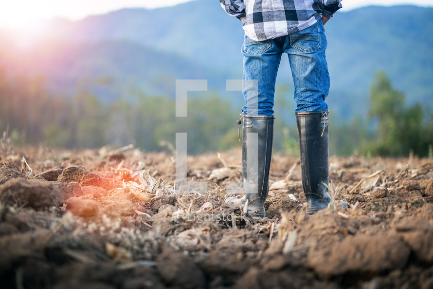 man with rubber boots farming 