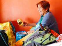 A grandmother with camping gear 