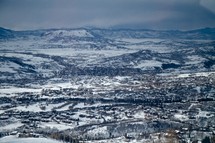 aerial view of a snow covered mountain range and valley