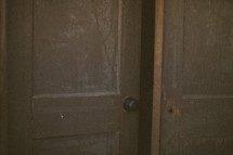 A wooden door cracked open