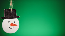 Christmas snowman decoration with green background