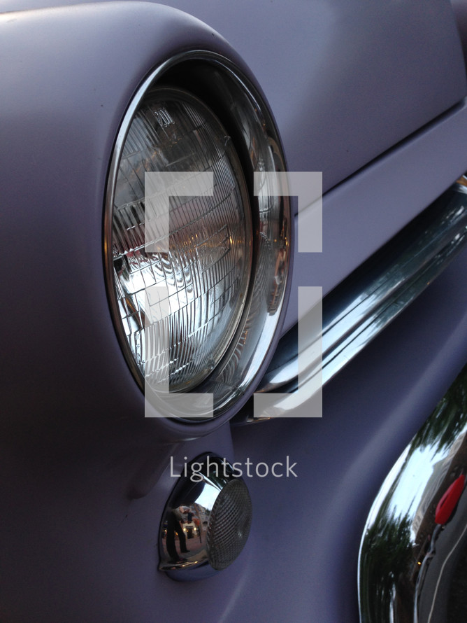 closeup of a vintage automobile headlamp, fender
