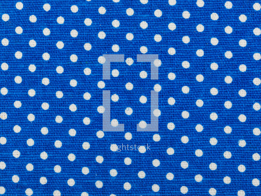 white polk dots on blue fabric background 