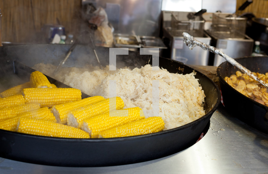 Pot with cabbage and corn in a market, street food.