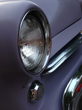 closeup of a vintage automobile headlamp, fender