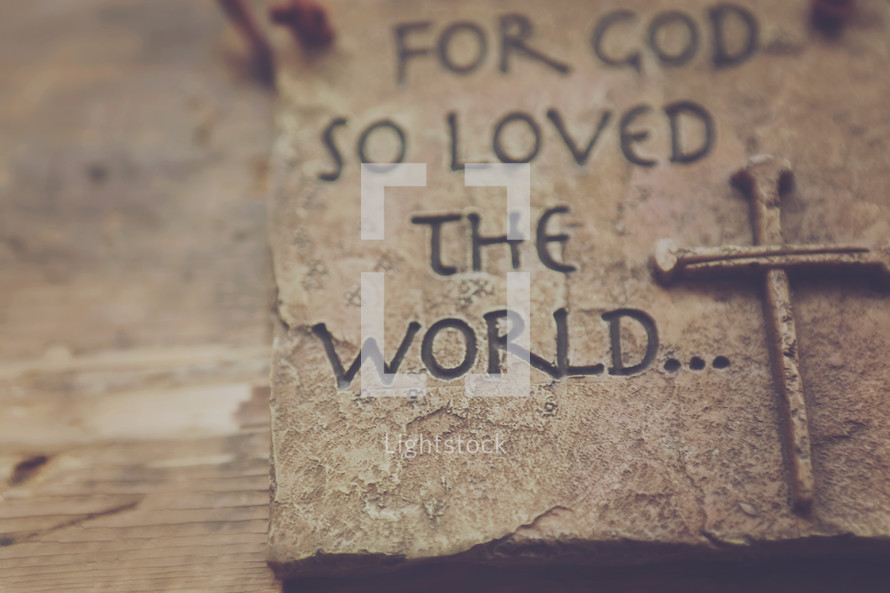 A plaque reading, "For God so loved the world."
