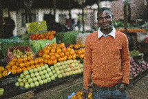A man standing in a farmers market in Malawi, Africa. 