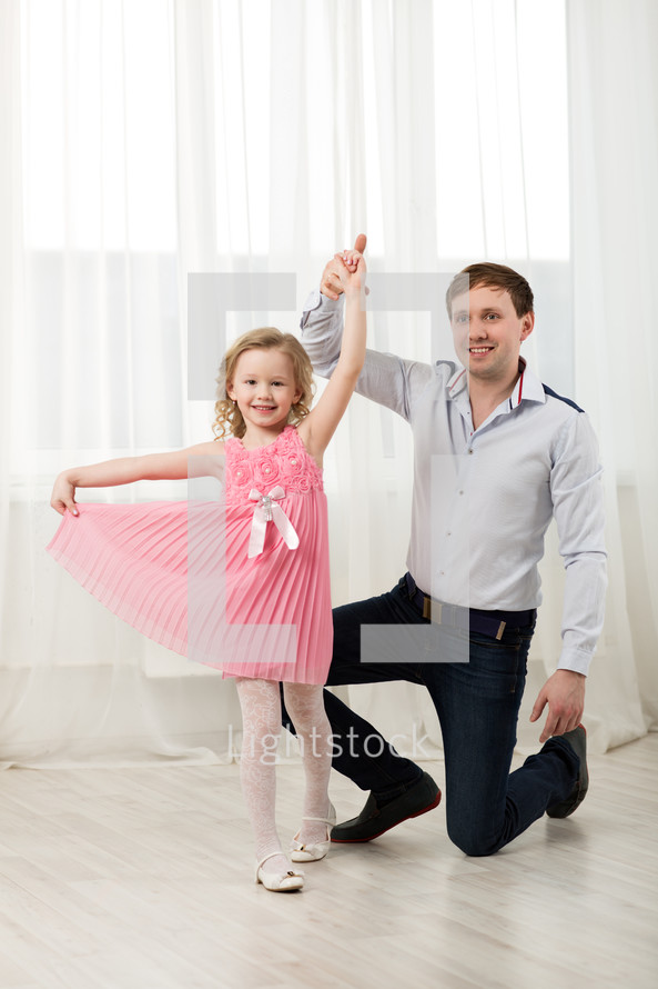Little princess dancing with father
