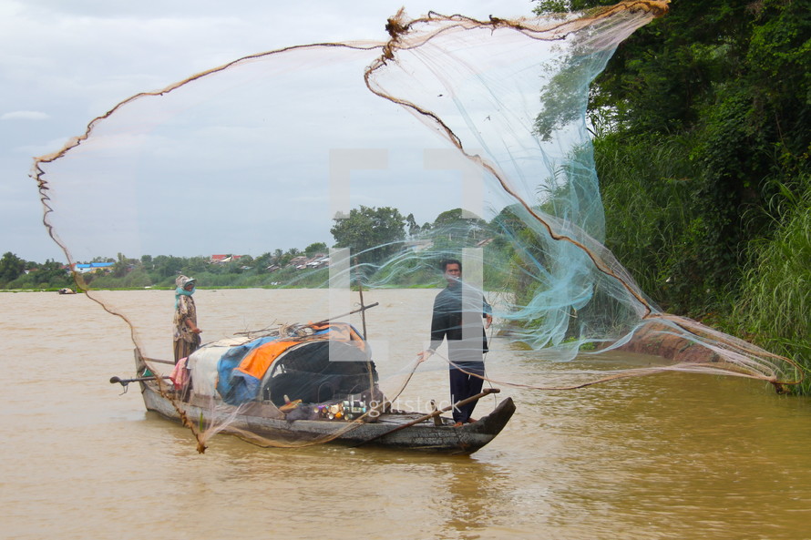 Nomadic fisherman casting a throw net to catch fish