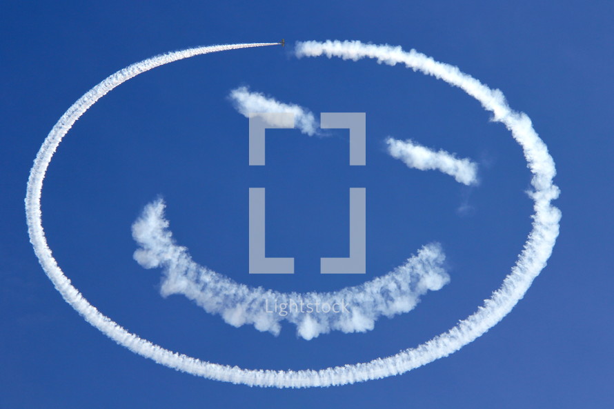 Sky writing a happy face in the cobalt blue sky
