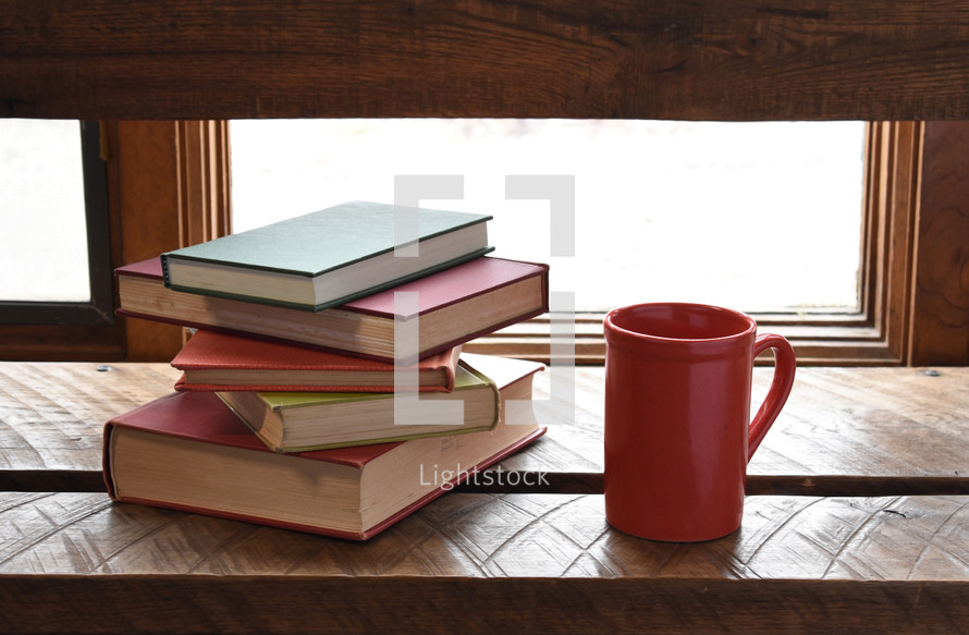 stack of books and a coffee mug 