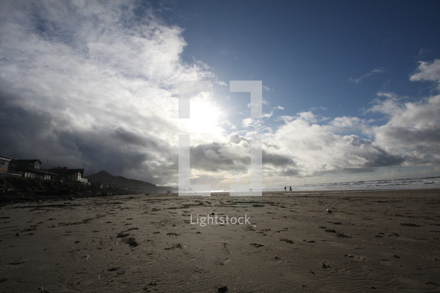 clouds and a blue sky over sand on a beach
