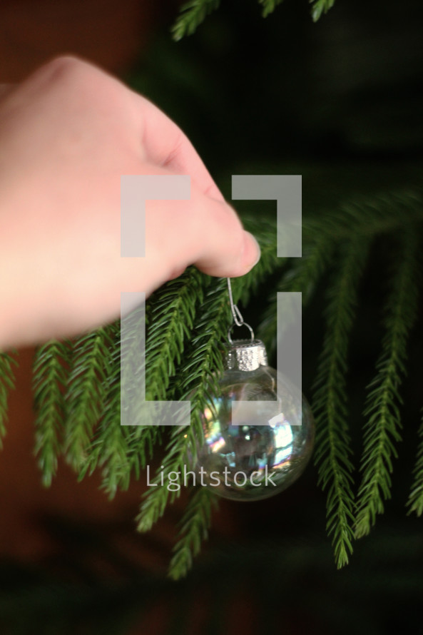hanging a Christmas ornament 