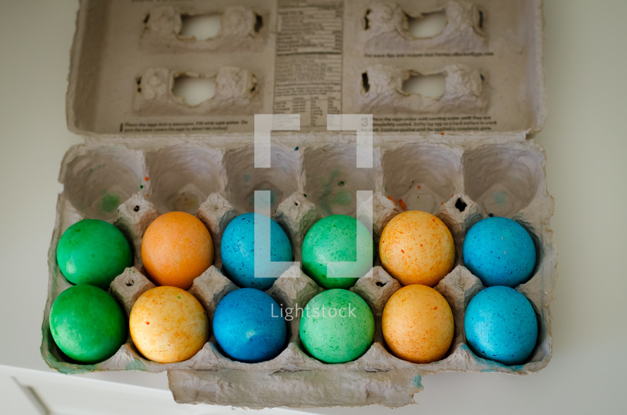 dyed Easter eggs in an egg carton 