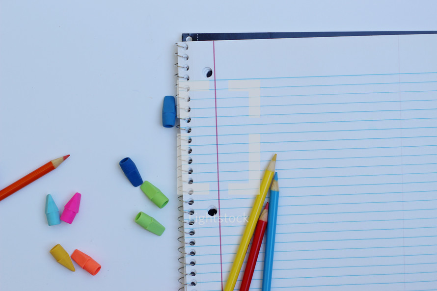 colored pencils, erasers, and spiral notebook 