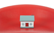 House model toy plastic in hand on red background