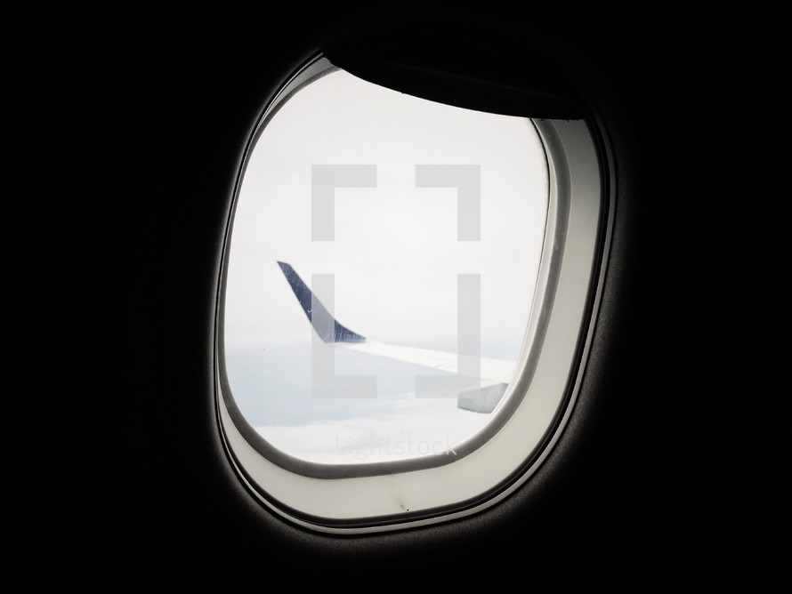 wing of plane out an airplane window 
