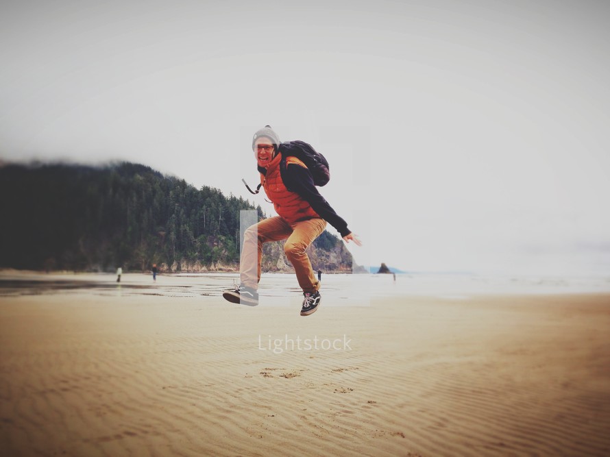 man jumping at the beach