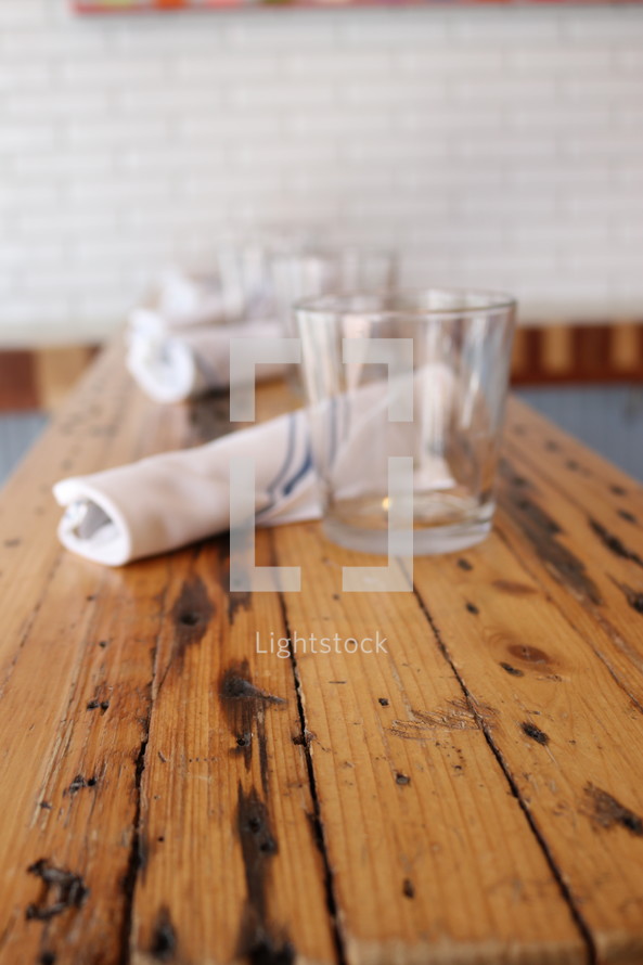 napkins and glasses on a wooden table 