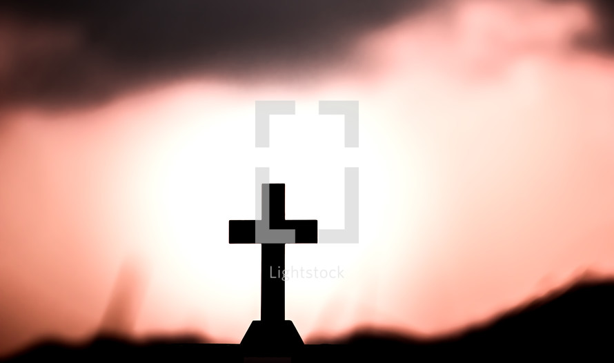 cross silhouette against a red sky at sunset 